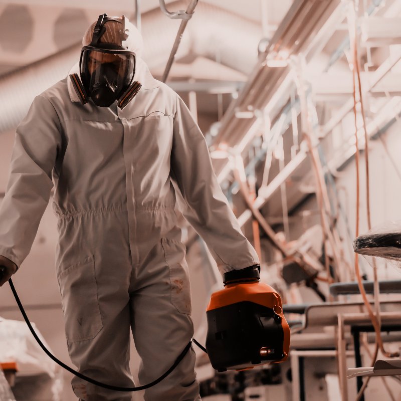 worker in a hazmat suit providing biohazard cleanup