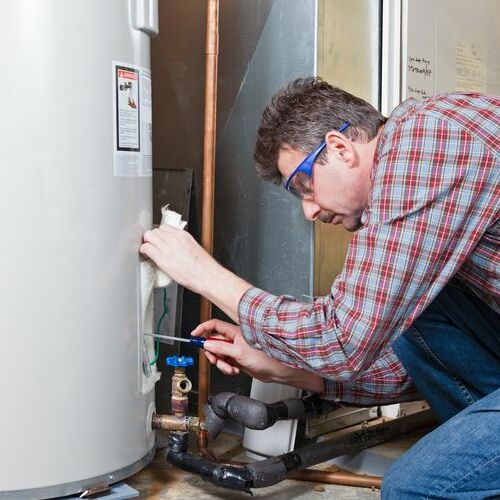 A Technician Repairs a Water Heater.